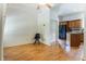 Bright living room featuring hardwood floors, a modern ceiling fan, and a view into the kitchen at 602 Prospect St, Indianapolis, IN 46203