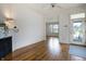 Bright living room with fireplace and hardwood floors, leading to a doorway and outdoor view at 602 Prospect St, Indianapolis, IN 46203