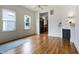 Living room featuring hardwood floors, natural light, and a view into the adjacent kitchen at 602 Prospect St, Indianapolis, IN 46203