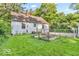 Green backyard features space for garden, mature trees, and classic yard design offering ample outdoor space at 6235 N Temple Ave, Indianapolis, IN 46220