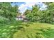 Lush backyard with mature trees, providing ample space for outdoor activities and entertaining at 6235 N Temple Ave, Indianapolis, IN 46220