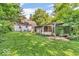 Lush backyard showcasing a pergola, mature trees and greenery, providing ample space for outdoor relaxation and activities at 6235 N Temple Ave, Indianapolis, IN 46220