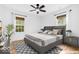 Stylishly furnished bedroom with neutral tones, hardwood floors, and ample natural light from two windows at 6235 N Temple Ave, Indianapolis, IN 46220