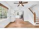 Open dining area and kitchen with white cabinetry, stainless steel appliances, and a ceiling fan at 6235 N Temple Ave, Indianapolis, IN 46220