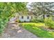 Charming home featuring a well-maintained lawn, mature trees, and a quaint design at 6235 N Temple Ave, Indianapolis, IN 46220