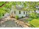 Charming two-story home with landscaped yard, wood accents, and a detached garage at 6235 N Temple Ave, Indianapolis, IN 46220