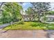 Charming home with a well-manicured lawn, mature trees, and vibrant greenery creating inviting curb appeal at 6235 N Temple Ave, Indianapolis, IN 46220