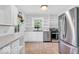 Bright eat-in kitchen features stainless steel appliances and built-in shelving at 6235 N Temple Ave, Indianapolis, IN 46220