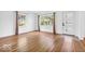 Neutral room with hardwood floors, white walls and a modern front door at 6235 N Temple Ave, Indianapolis, IN 46220
