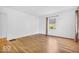 Bright room with hardwood floors, white walls, large window, and neutral finishes at 6235 N Temple Ave, Indianapolis, IN 46220