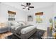Staged bedroom boasts hardwood floors and is filled with natural light at 6235 N Temple Ave, Indianapolis, IN 46220