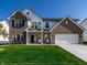 Charming two-story home with brick and siding, well-manicured lawn, and a two-car garage at 628 Tess Blvd, Westfield, IN 46074