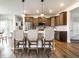 Modern kitchen with stainless steel refrigerator and appliances, an island with pendant lights and seating at 628 Tess Blvd, Westfield, IN 46074