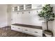 Organized mudroom featuring built-in storage, a bench with drawers, hooks, and overhead shelves, complemented by wood floors at 628 Tess Blvd, Westfield, IN 46074