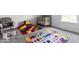 Cozy playroom with carpet flooring, featuring a comfortable glider, crib, and colorful, educational play mats at 628 Tess Blvd, Westfield, IN 46074