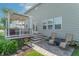 Inviting backyard patio featuring a pergola-covered deck and a charming stone paver area with chairs at 6480 E Coal Bluff Ct, Camby, IN 46113
