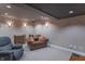 Finished basement area with neutral carpet, recessed lighting, and cozy seating arrangement at 6480 E Coal Bluff Ct, Camby, IN 46113