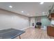 Finished basement featuring hardwood floors, a ping pong table, and a wet bar for entertainment at 6480 E Coal Bluff Ct, Camby, IN 46113