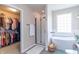 Bathroom boasts a stand-alone tub, glass shower, and a walk-in closet for storage at 6480 E Coal Bluff Ct, Camby, IN 46113