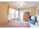 Cozy bedroom with soft lighting, a cushioned chair, and closet space at 6480 E Coal Bluff Ct, Camby, IN 46113