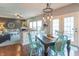 Inviting dining area with stylish chandelier, opening into a cozy living room with a fireplace at 6480 E Coal Bluff Ct, Camby, IN 46113