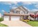Charming two-story home with a brick and siding exterior, manicured landscaping, and a spacious driveway at 6480 E Coal Bluff Ct, Camby, IN 46113