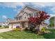 Beautiful home featuring a lush front yard with a vibrant red Japanese maple tree at 6480 E Coal Bluff Ct, Camby, IN 46113