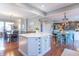 Open-concept kitchen with a center island, stainless steel appliances, and adjacent dining area at 6480 E Coal Bluff Ct, Camby, IN 46113