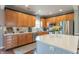 Spacious kitchen features stainless steel appliances, quartz countertops and hardwood floors at 6480 E Coal Bluff Ct, Camby, IN 46113