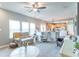 Bright living room features large windows, gray walls, and an open layout leading to the kitchen at 6480 E Coal Bluff Ct, Camby, IN 46113