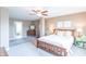 Comfortable main bedroom features a ceiling fan, ensuite bath, and calming neutral tones at 6480 E Coal Bluff Ct, Camby, IN 46113