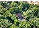 An aerial view of a secluded home nestled in a lush, green forest, offering privacy and natural beauty at 6975 Milhouse Rd, Indianapolis, IN 46221