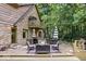 Picturesque backyard deck with outdoor seating and umbrellas, complemented by a stone and wood home exterior at 6975 Milhouse Rd, Indianapolis, IN 46221