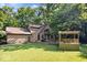Expansive backyard featuring a deck, covered outdoor space, and lush green lawn at 6975 Milhouse Rd, Indianapolis, IN 46221