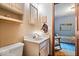 Bathroom featuring a modern sink and vanity, and a partial view of the bedroom at 6975 Milhouse Rd, Indianapolis, IN 46221