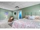 Basement bedroom with green walls, plush carpet, and decorative shutters over the window at 6975 Milhouse Rd, Indianapolis, IN 46221