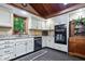 Bright kitchen features white cabinetry, granite countertops, stainless appliances and a dark tile floor at 6975 Milhouse Rd, Indianapolis, IN 46221