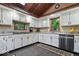Well-lit kitchen features white cabinets, granite countertops, stainless steel appliances, and tiled flooring at 6975 Milhouse Rd, Indianapolis, IN 46221