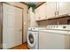 Functional laundry room equipped with modern washer and dryer units at 6975 Milhouse Rd, Indianapolis, IN 46221