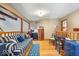 Inviting living room with hardwood floors, a striped sofa, and a view of the staircase at 6975 Milhouse Rd, Indianapolis, IN 46221