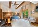 Well-lit bedroom featuring wood beam ceiling, decorative wallpaper, and walk out patio at 6975 Milhouse Rd, Indianapolis, IN 46221