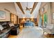 Spacious main bedroom with wood beam ceiling, decorative wallpaper, and walk out patio at 6975 Milhouse Rd, Indianapolis, IN 46221