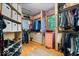 Spacious walk-in closet with custom shelving, organized clothing, and a window for natural light at 6975 Milhouse Rd, Indianapolis, IN 46221