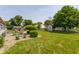 Landscaped backyard featuring mature trees, a cozy seating area, and a storage shed at 7 Pondview Ct, Brownsburg, IN 46112