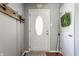 Inviting entryway with a white door, coat rack, and a wreath hanging in the background at 7 Pondview Ct, Brownsburg, IN 46112