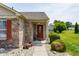 Welcoming covered front entry with a decorative red door and landscaped surroundings at 7 Pondview Ct, Brownsburg, IN 46112