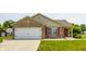 Charming single-story home with a brick facade, attached garage, and well-manicured lawn at 7 Pondview Ct, Brownsburg, IN 46112