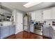 Well-lit kitchen showcasing stainless steel appliances, white subway tile backsplash, and painted cabinets at 7 Pondview Ct, Brownsburg, IN 46112