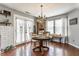 Bright kitchen with white cabinets, hardwood floors, breakfast table and french doors at 7 Pondview Ct, Brownsburg, IN 46112
