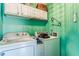Bright laundry room with white appliances and upper cabinets for convenient storage solutions at 7 Pondview Ct, Brownsburg, IN 46112